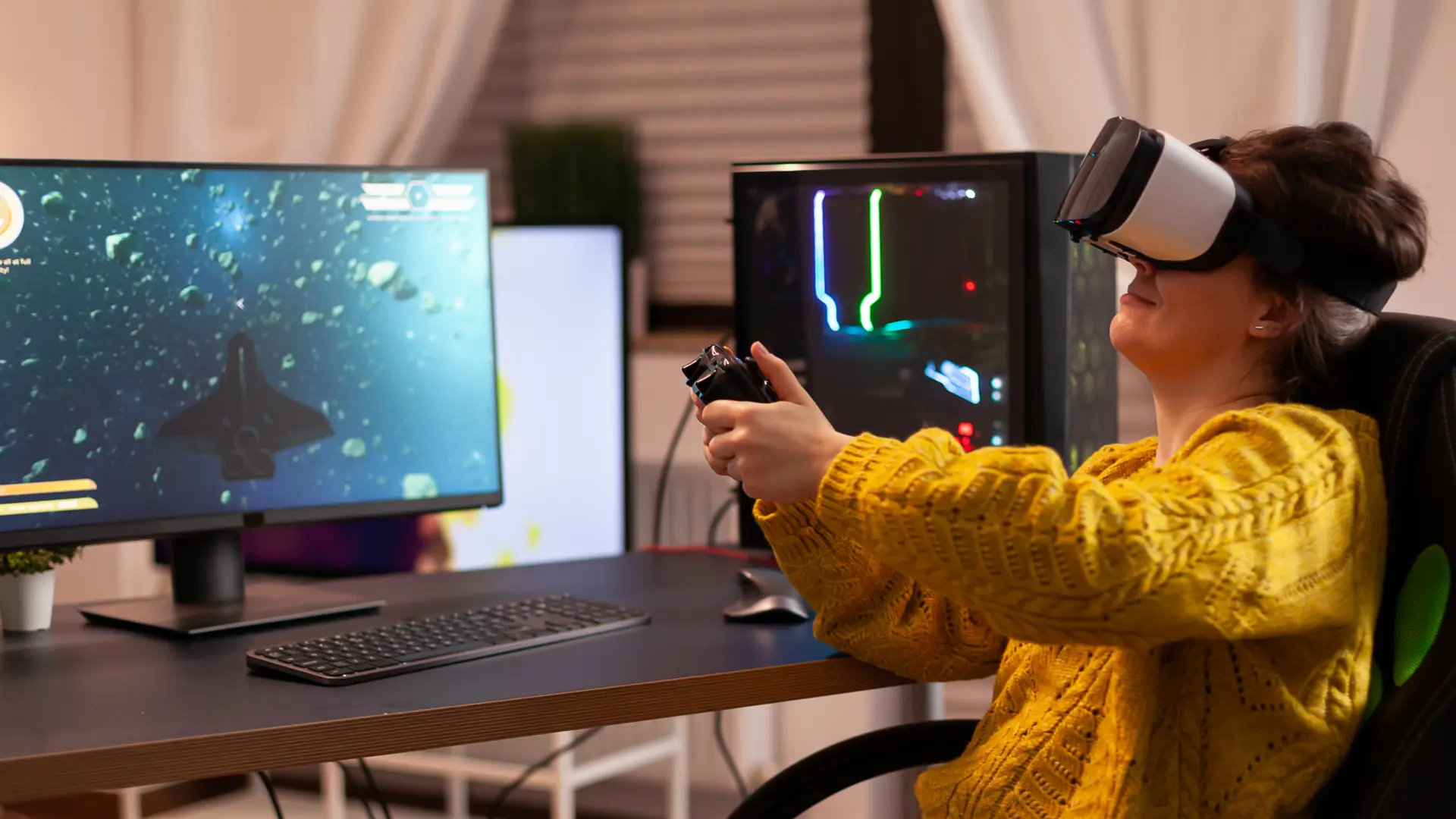 Woman in yellow sweater using a VR headset and controller beside a PC showing a 3D space game, symbolizing 3D game evolution